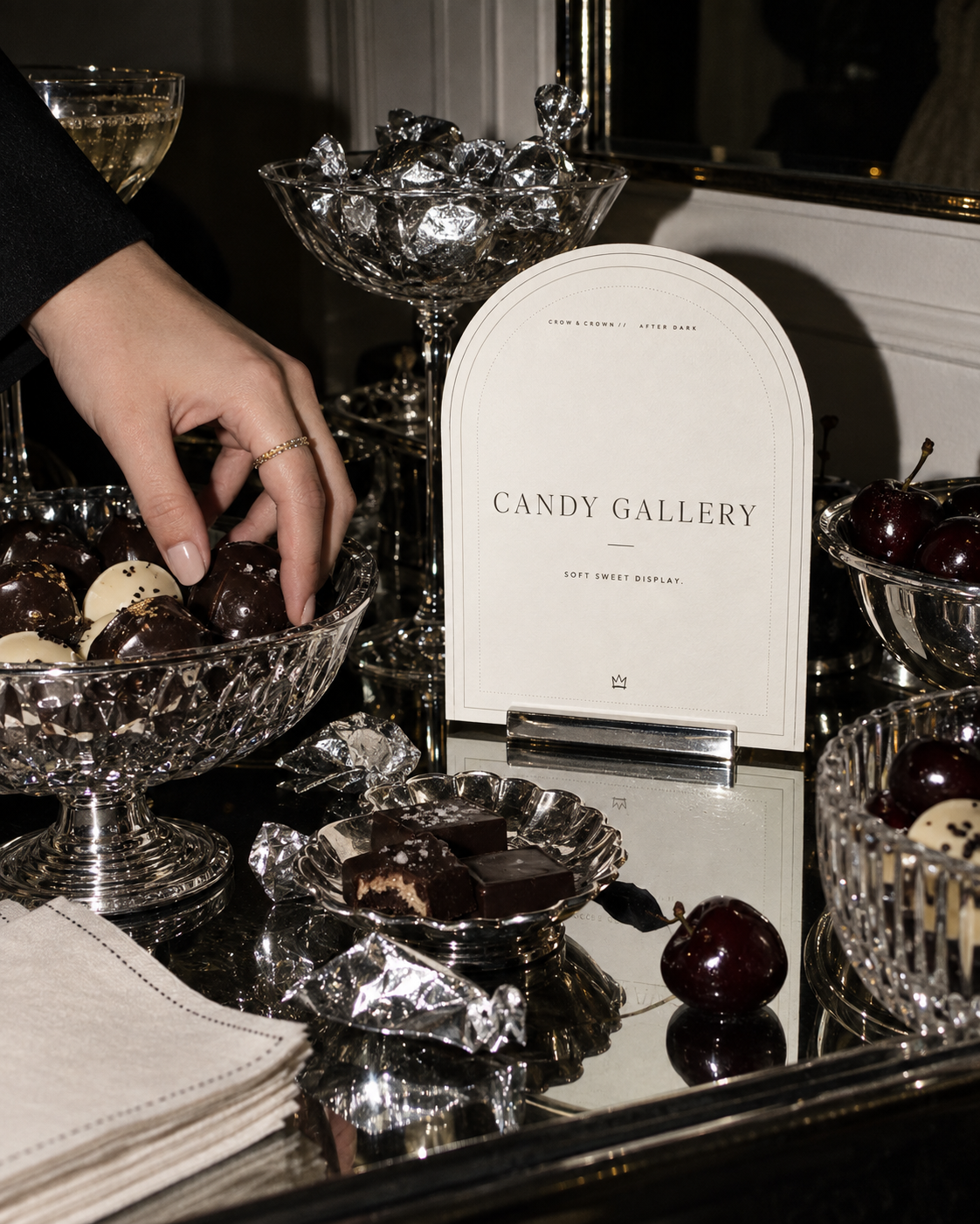 Candy Gallery printable sign with chocolates and cherries in cut-glass bowls on a mirrored table