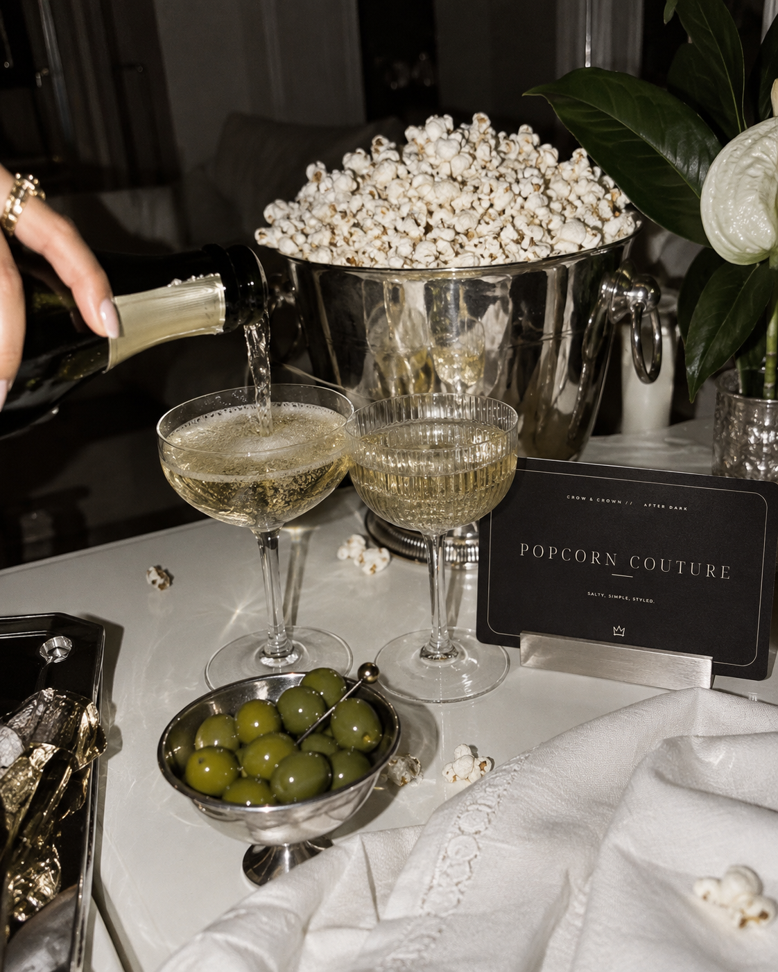 The After Dark Party Popcorn Couture printable sign styled with champagne and silver popcorn service