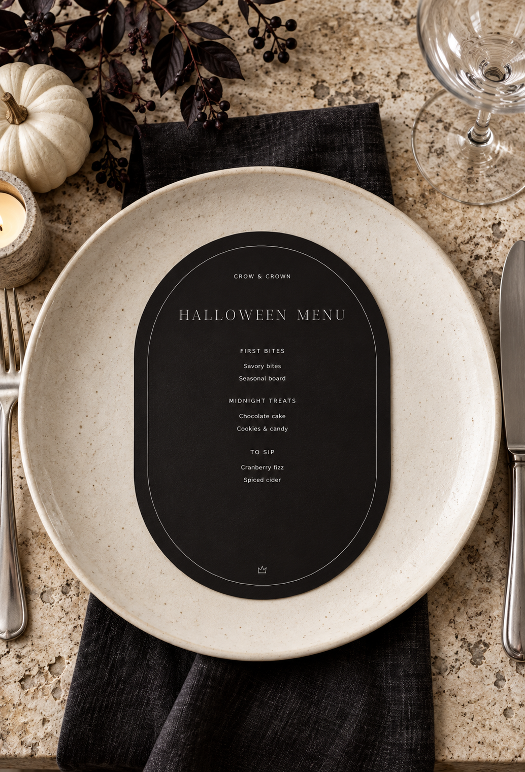 Near-black Halloween menu printable on an ivory plate with a dark linen napkin