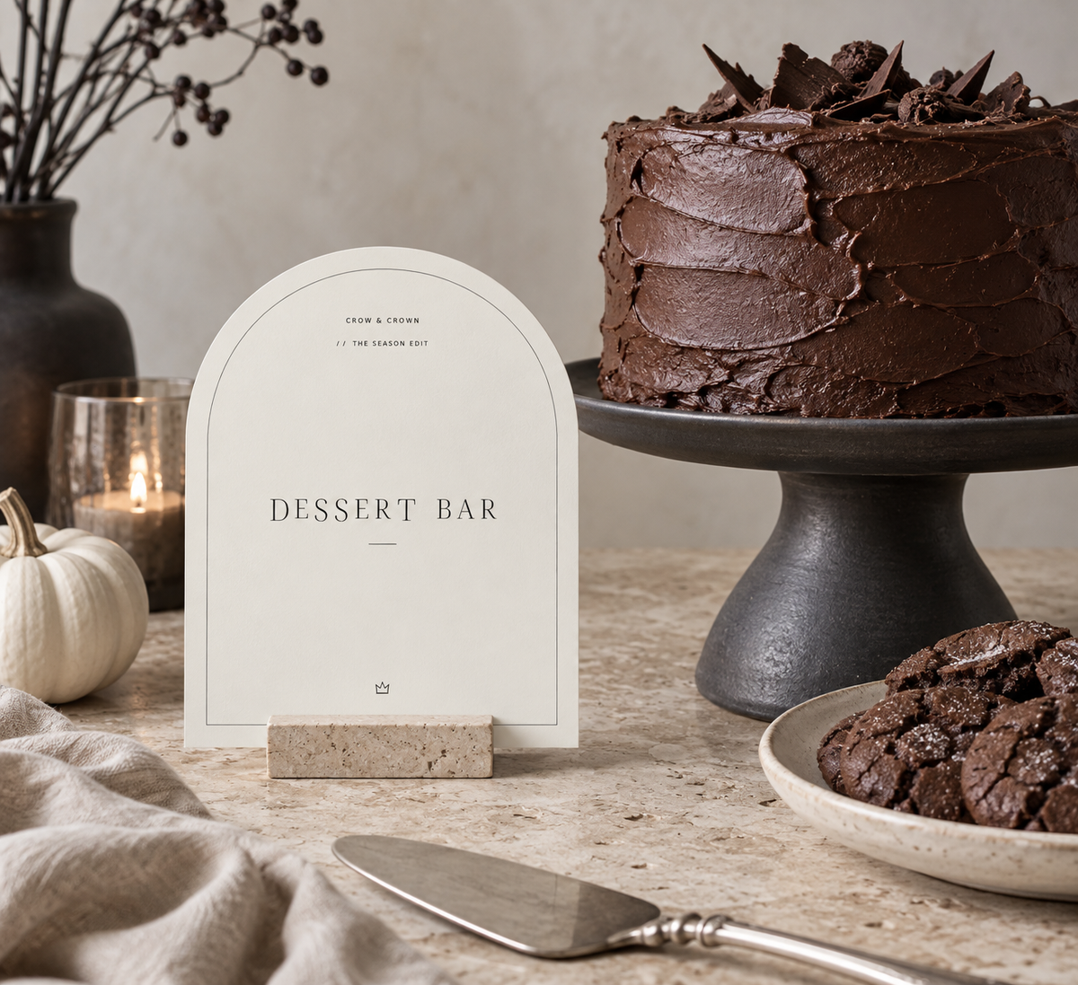 Ivory Dessert Bar Halloween printable beside a chocolate cake on a black stand