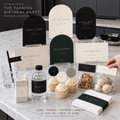 Fashion birthday arched signs, bottle labels, food cards and cupcake toppers on a marble counter