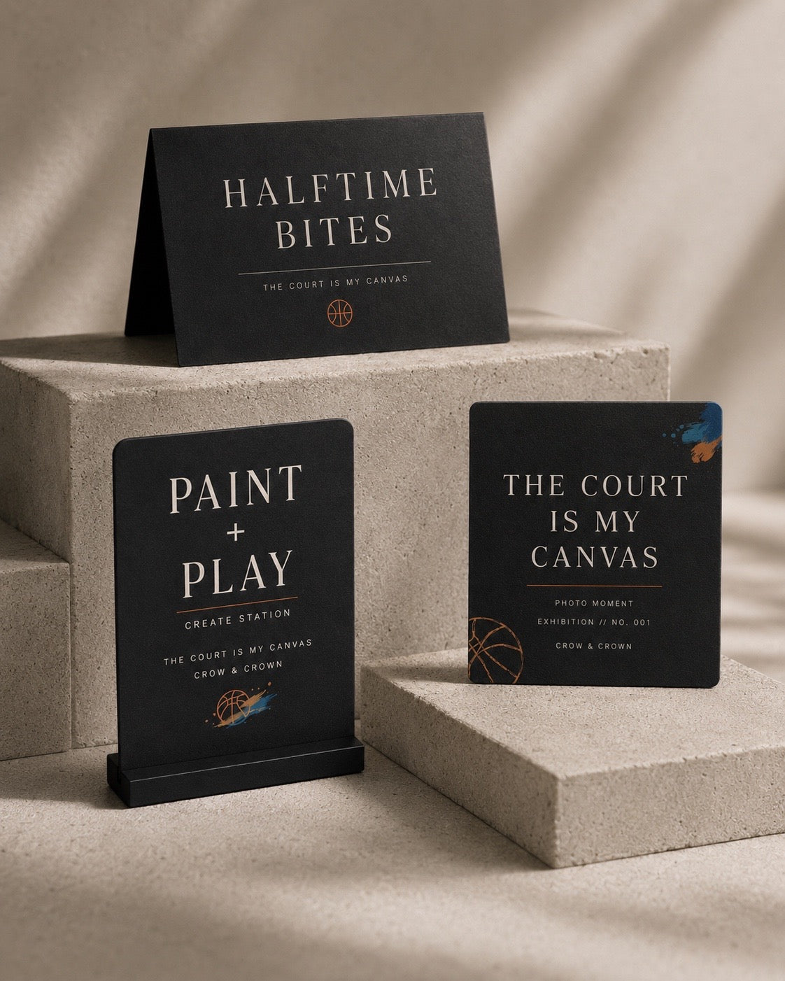 The Court Is My Canvas matte black party signage on concrete plinths