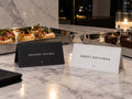 Savory Hours and Sweet Nothings printable food tent cards displayed on a marble buffet