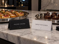 Savory Hours and Sweet Nothings cocktail-party tent cards beside canapés and brownies