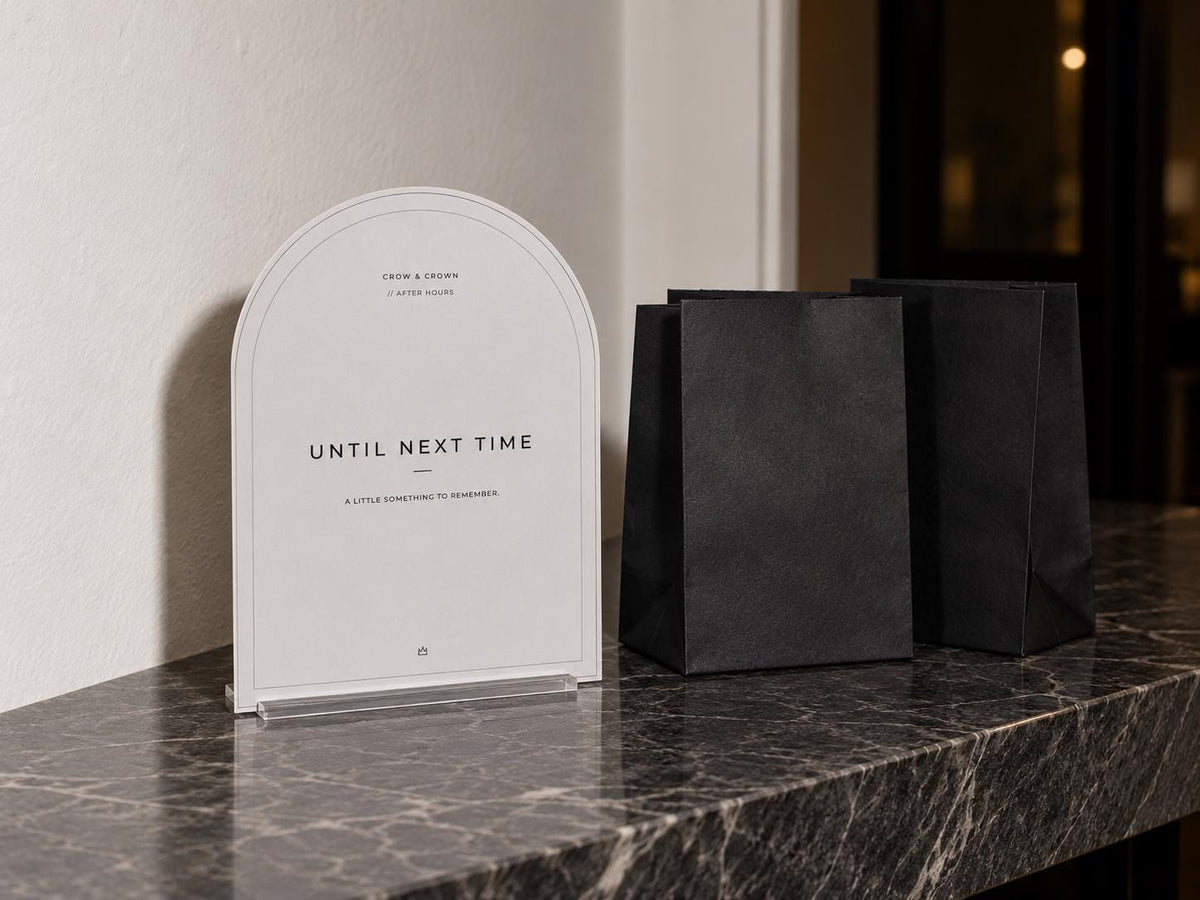 Until Next Time cocktail-party printable beside black favor bags on a console