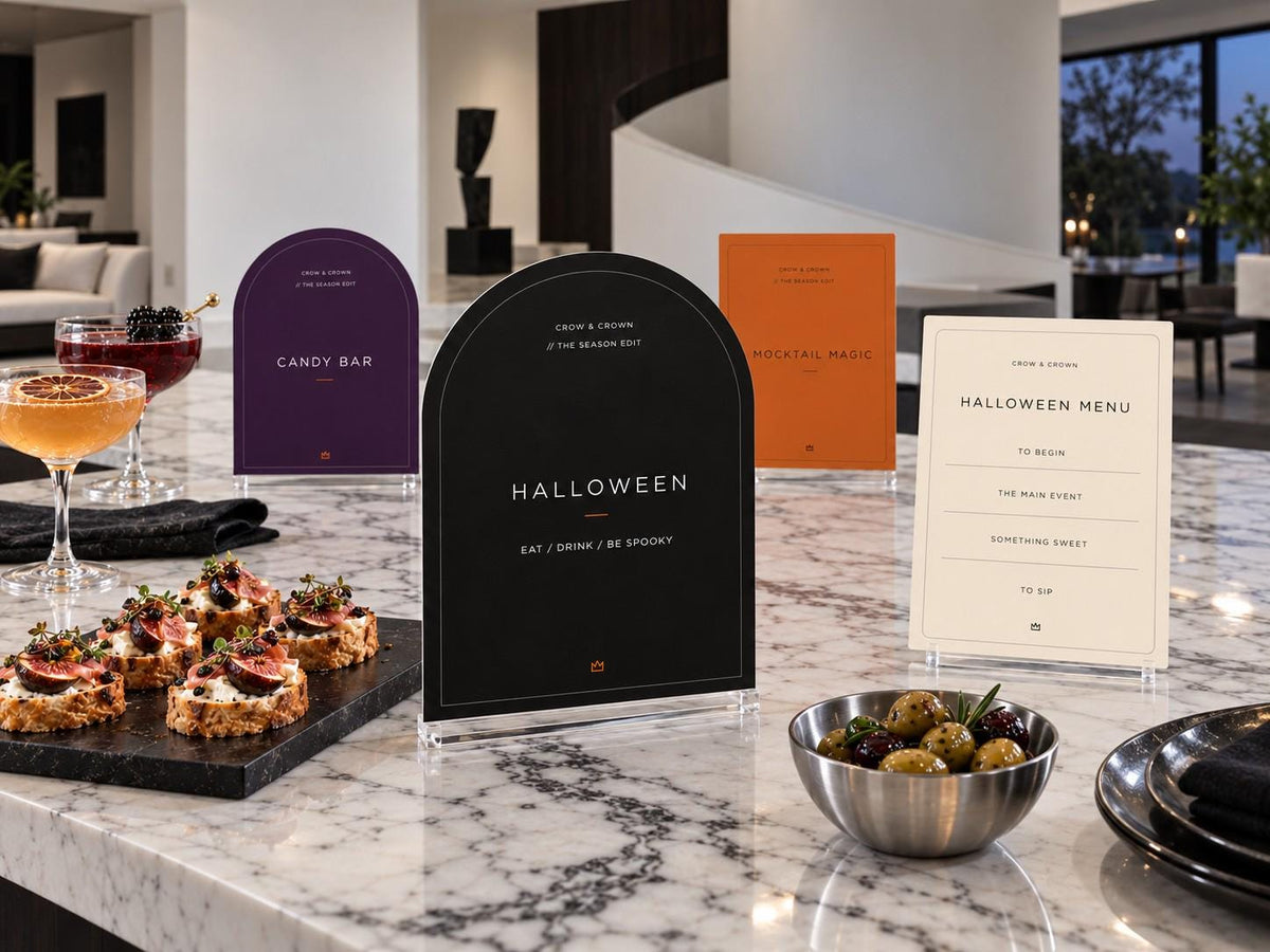 Halloween Edit station signs and ivory menu with food cards on a modern marble island