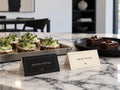 Black Savory Bites and ivory Sweet Bites Halloween tent cards beside canapés and brownies