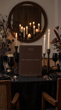 The Haunt Is Open Halloween printable at a dark candlelit dining table