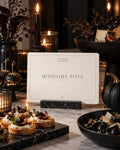 Midnight Bites Halloween printable behind small savory bites and dark pumpkins