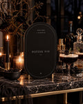 Near-black Potion Bar Halloween printable among dark drinks, candles and glassware