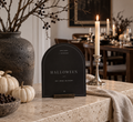 Halloween arched welcome printable with ivory pumpkins, branches and a candle on a stone console
