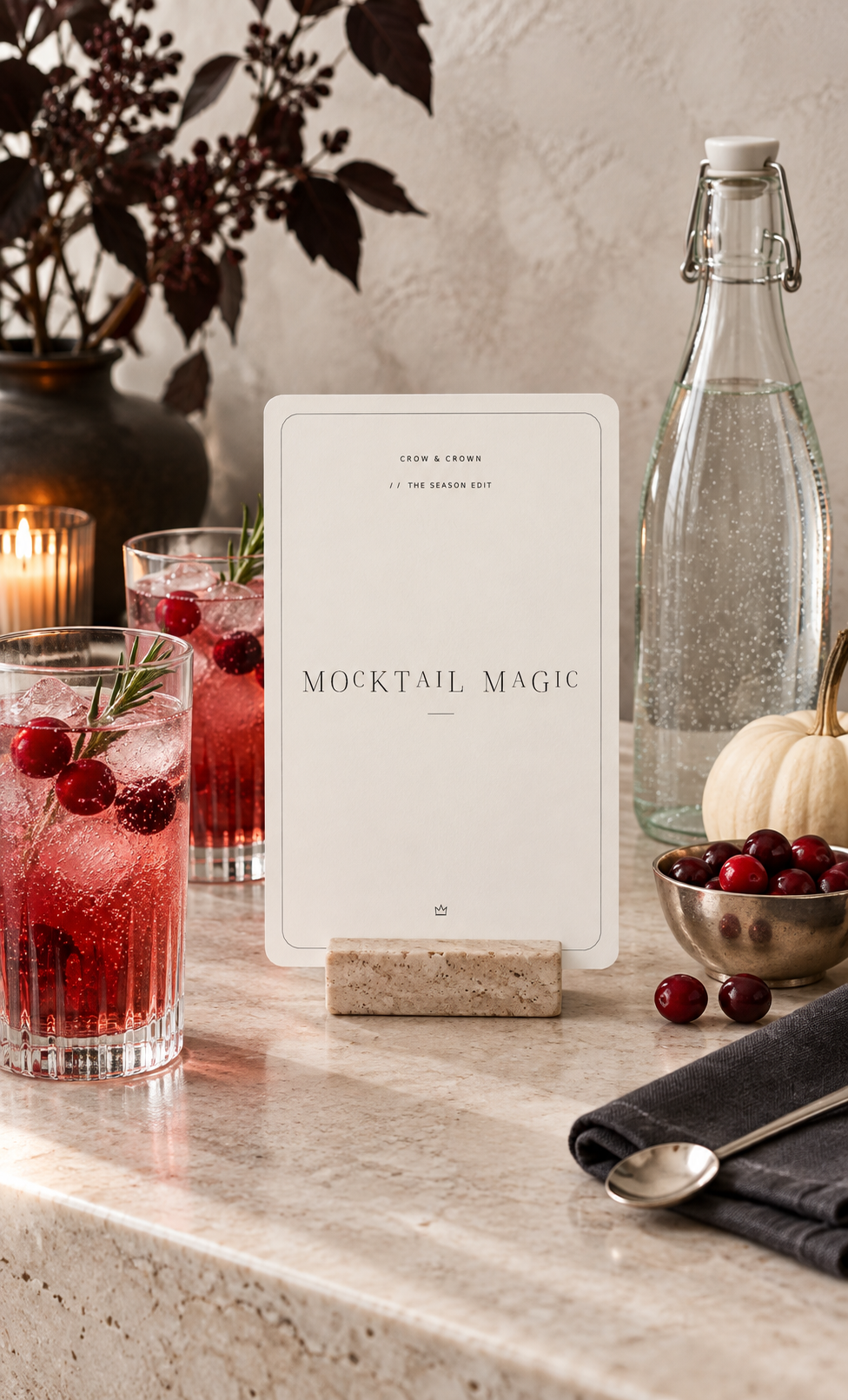 Mocktail Magic Halloween printable beside red drinks and a clear glass bottle