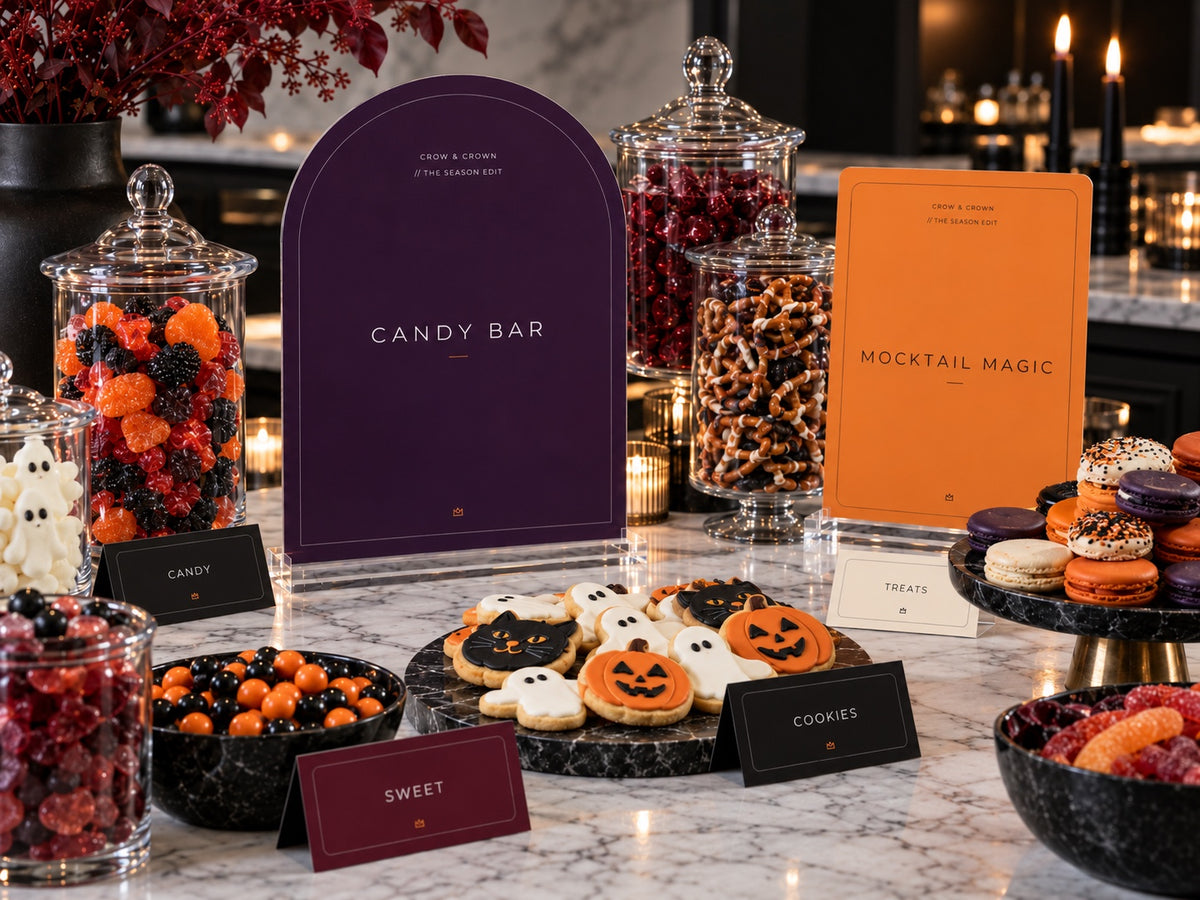 Purple Candy Bar and orange Mocktail Magic Halloween signs with jars of candy and decorated cookies
