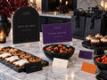 Trick or Treat and Please Take One Halloween signs with black favor bags and cookie trays