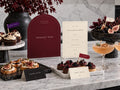 Burgundy Dessert Bar and ivory Halloween menu printables beside tarts, savory bites and cocktails