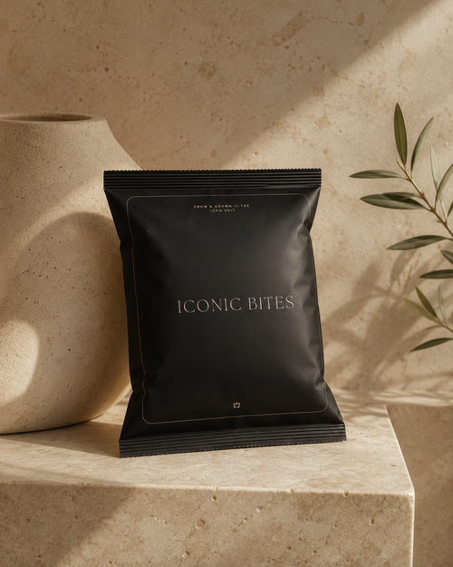 Iconic Bites small black chip bag mockup on marble slab with organic modern styling