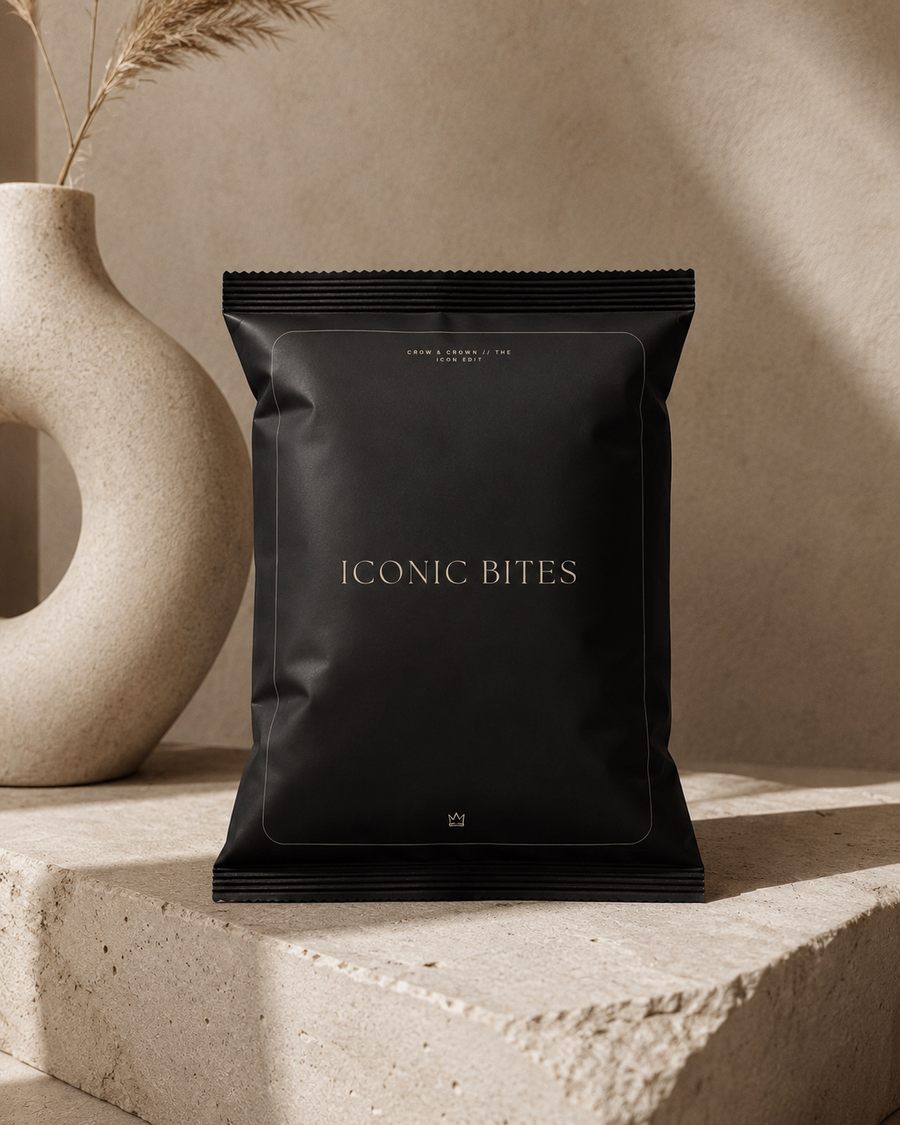 Iconic Bites small black chip bag mockup on stone with sculptural vase