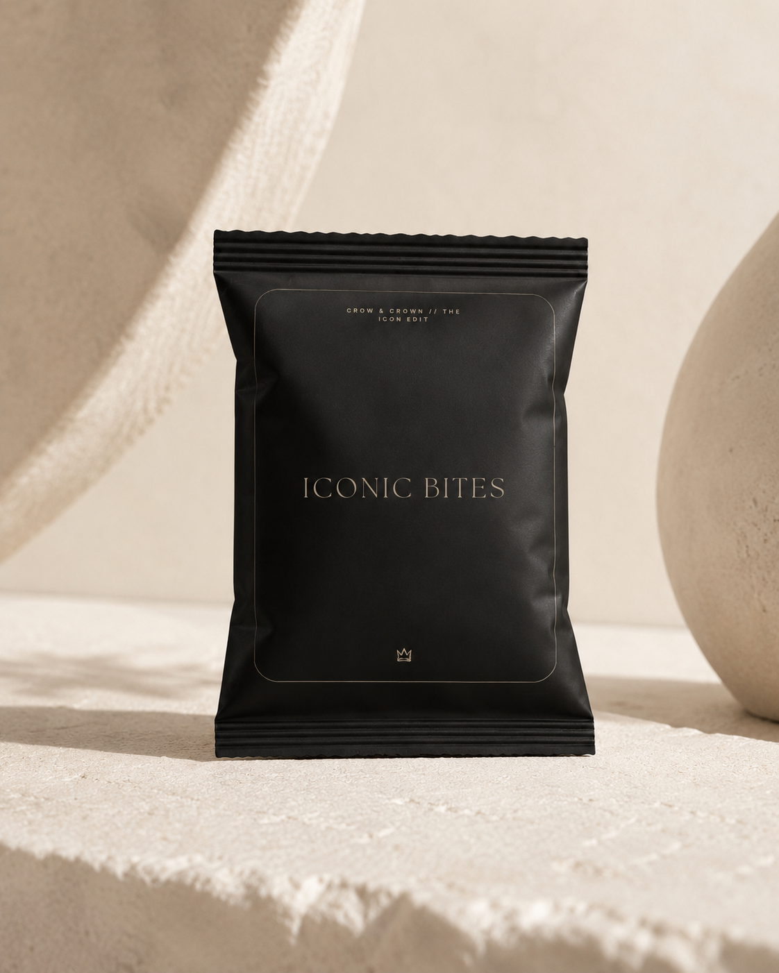 Iconic Bites small black chip bag mockup on textured stone backdrop