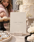 Cake Table fashion birthday printable beside a white cake, crown cookies and macarons