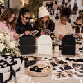 Fashion birthday lookbook activity scene with station signs, craft materials and children around a table