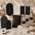 Fashion birthday printable signs, black snack wraps and bottle labels displayed on a stone table