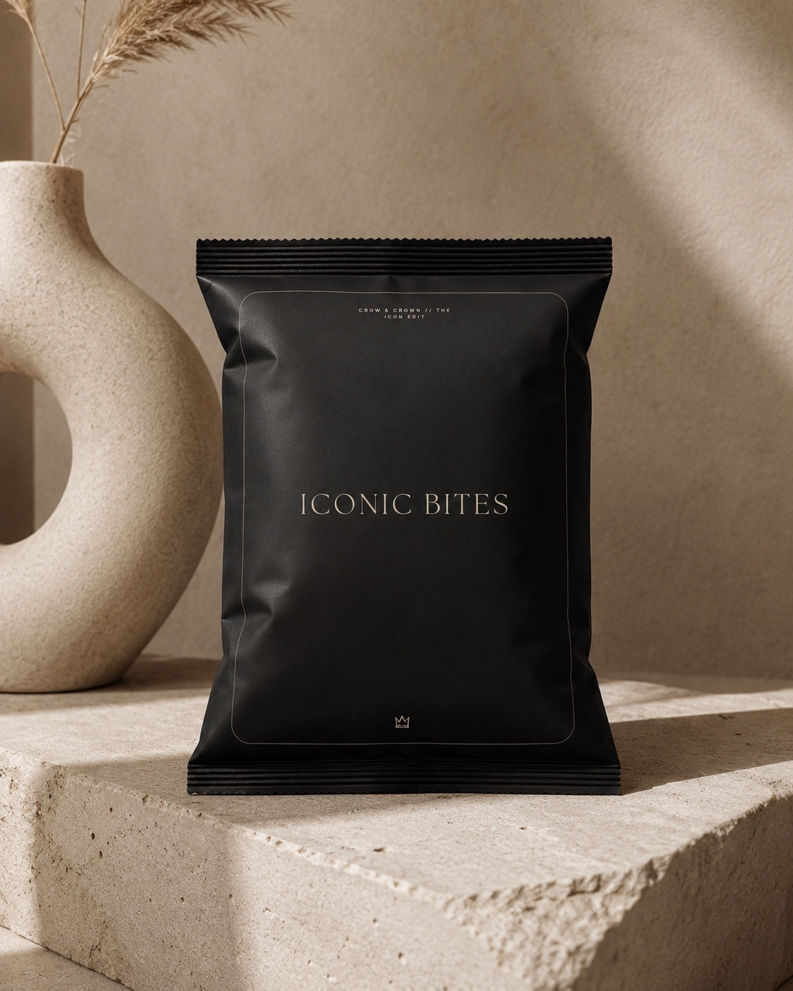 Black Iconic Bites printable chip-bag wrapper on a stone plinth