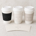 Black and ivory fashion birthday cup sleeves on three white takeaway cups