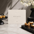 Mini Bites printable fashion birthday sign beside small desserts on a marble table