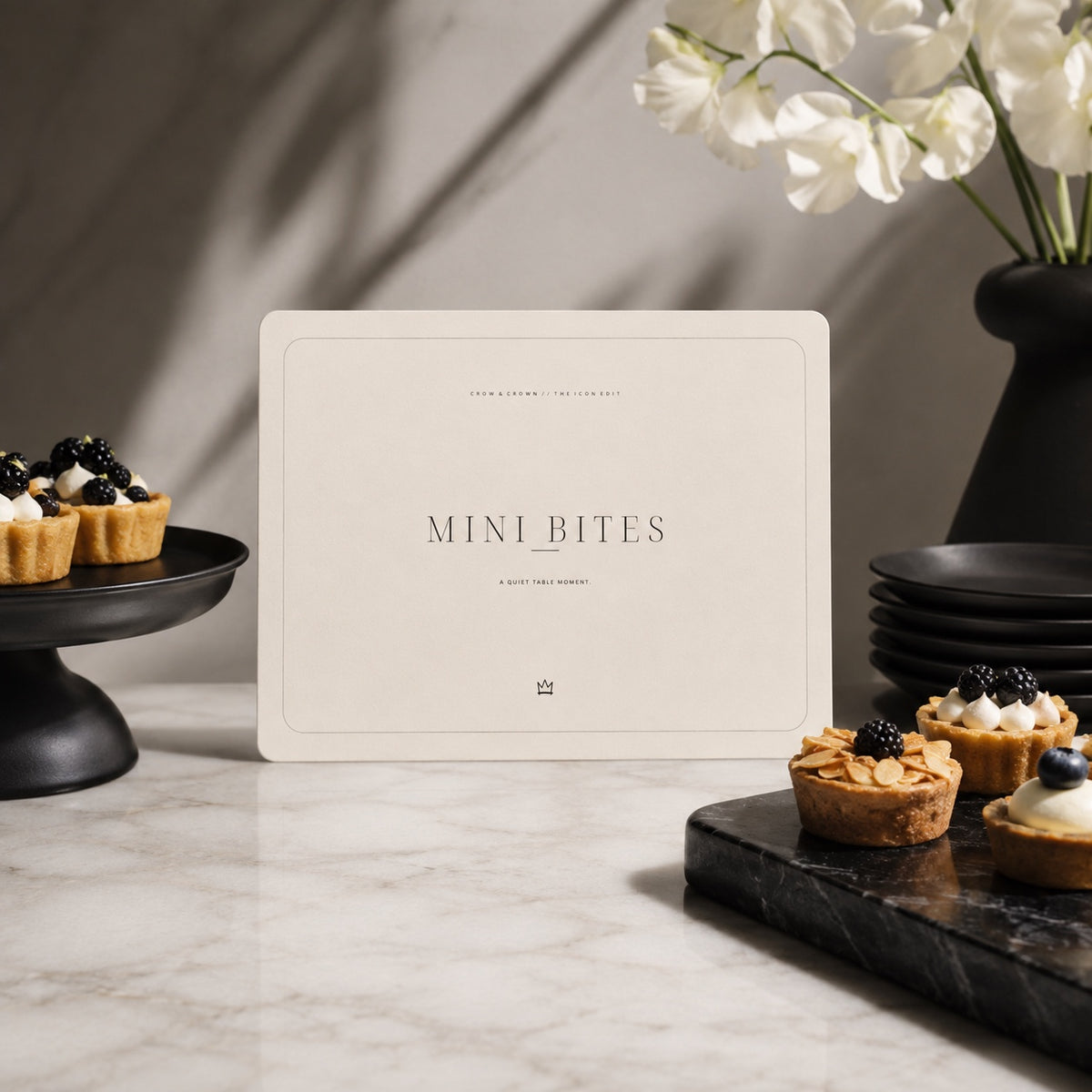 Mini Bites printable fashion birthday sign beside small desserts on a marble table